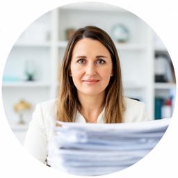 Solicitor Mairead Kavanagh in a bright Dublin office, seated beside a pile of case notes